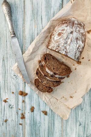 Freshly baked wheat bread, homemade cakes, still life with bread, crisp loaf of bread, still life on a rustic background, top view, rustic bread, roll, loaf. の写真素材