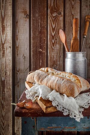Freshly baked wheat bread, homemade cakes, still life with bread, crisp loaf of bread, still life on a rustic background, top view, rustic bread, roll, loaf.の写真素材