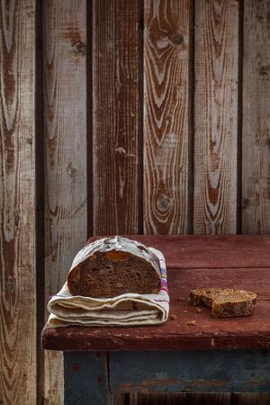 Freshly baked wheat bread, homemade cakes, still life with bread, crisp loaf of bread, still life on a rustic background, top view, rustic bread, roll, loaf.の写真素材