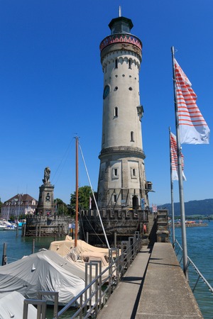 Harbor entrance in Lindau on Lake Constance with the landmark lion and lighthouse, Bavaria, Germanyの写真素材