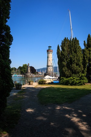Harbor entrance in Lindau on Lake Constance with the landmark lion and lighthouse, Bavaria, Germanyの写真素材