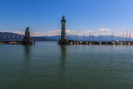 Harbor entrance in Lindau on Lake Constance with the landmark lion and lighthouse, Bavaria, Germanyの写真素材