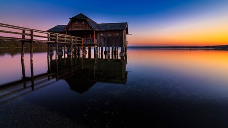 Boathouse in Stegen at the Ammersee at sunset in Bavaria Germanyの写真素材
