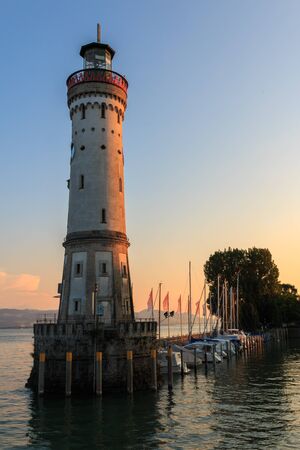 The lighthouse at the harbor entrance of the island Lindau at the Bodensee in Bavaria, Germanyの写真素材