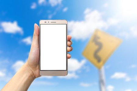 hand holding smartphone with blank screen on bluesky backgroundの写真素材