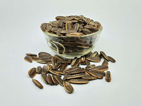 Sunflower seeds in a glass bowl isolated on white background. Close up.の写真素材