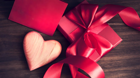Valentine's Day background with red gift box and red heartの写真素材