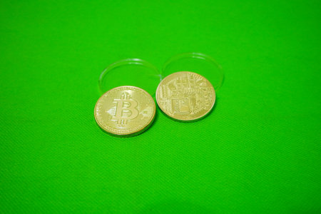 Bitcoin. Golden bitcoin isolated on green backgroundの写真素材