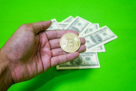 Bitcoin and US Dollar isolated on green backgroundの写真素材