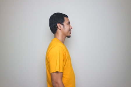 asian man smiling with yellow tshirt isolated on white background
