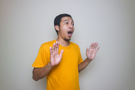 Portrait of young Asian man posing on white background