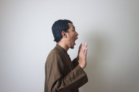 Moslem Asian man surprised expression looking to camera when Ramadan celebration. The photo is...