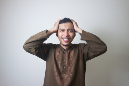 Moslem Asian man dizzy and headache face when Ramadan celebration. The photo is suitable to use for...