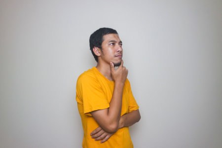 asian man thinking pose isolated on white background