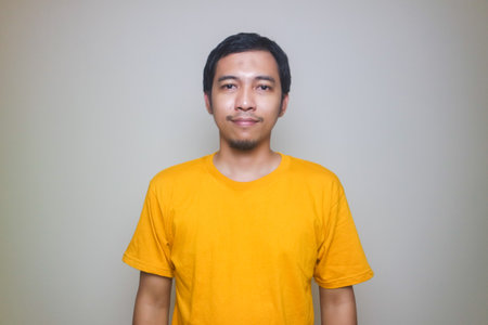 asian man smiling with yellow tshirt isolated on white background