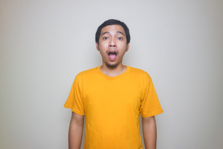 Portrait of young Asian man posing on white background