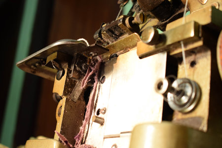Close up an antique Swan Overlock Sewing Machine on the wooden desk.