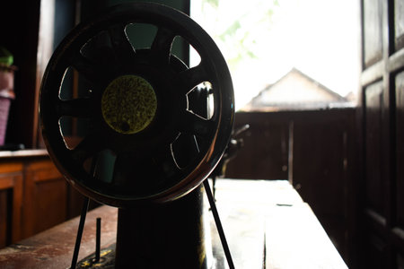 antique sewing machine with wheel on table wood