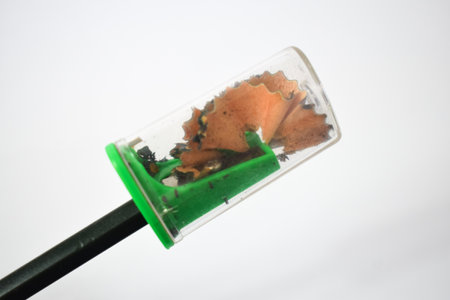 green pencil sharpener and dark green pencils on white backgroundの写真素材