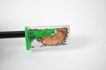 green pencil sharpener and dark green pencils on white backgroundの写真素材