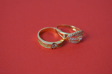 Close Up Golden ring with diamond on isolated red background