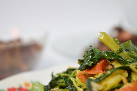 Close up stir fried spinach on white plate isolated white backgroundの写真素材