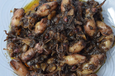 Close up Tumis Cumi, Oseng cumi or Stir Fried Squid placed on tranparent plate of glass isolated on...