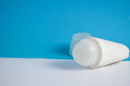 White bottle deodorant blank for mock up on blue background, product mock up, armpit health care, body careの写真素材
