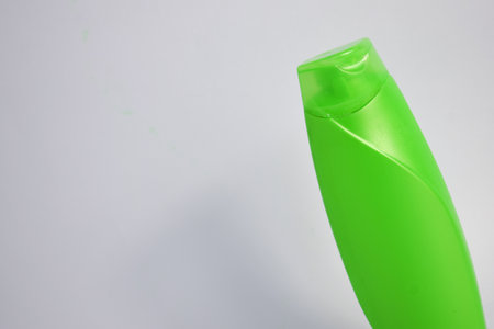 Green blank bottle shampoo minimalist bakcground, hair care bottle mock up product.