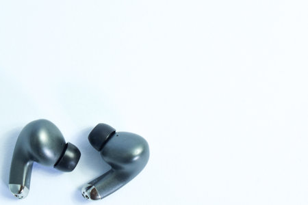 Silver wireless headset or earphone is called TWS, true wireless strereo for playing music without cable jack audio isolated on whote backgroundの写真素材