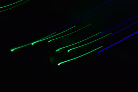 Long exposure colorful abstract line painting background isolated on black. curvy lines from led...