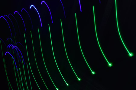 Long exposure colorful abstract line painting background isolated on black. curvy lines from led strip lighting on black backgroundの写真素材