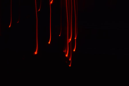 Long exposure colorful abstract line painting background isolated on black. curvy lines from led...