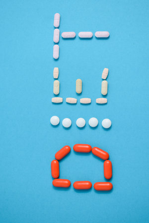 Diet word from Colorful Medicine Pills isolated on blue background, supplement, vitamin, colorfulの写真素材
