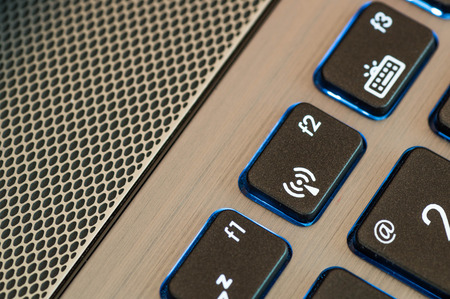 Close up shot of a blue illuminated keyboard WiFi signの写真素材