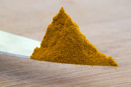 Macro shot of a knife tip with curcuma powder on itの写真素材