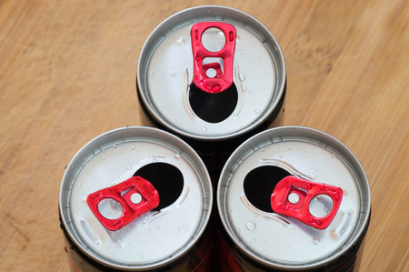 Three open and empty aluminum can next to each otherの写真素材