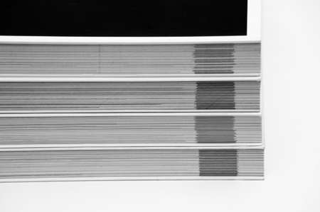 Black and white shot of a lot of books on each other, where only their edge is visibleの写真素材