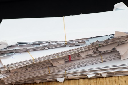 Close up view of envelope stack which are tied with rubber bandsの写真素材