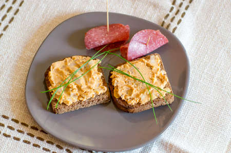 Prepared breakfast with bread, cream cheese and salami