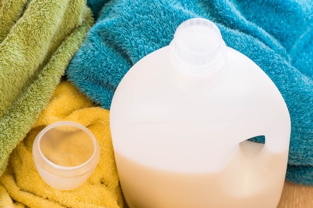 Bottle of liquid detergents with measuring cupの写真素材