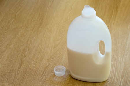Liquid detergents bottle with it's cup next to itの写真素材