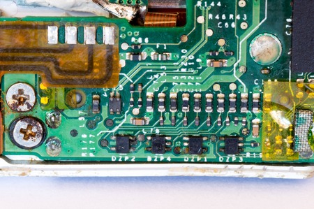 Rusty old screws and some transistors on a circuit board
