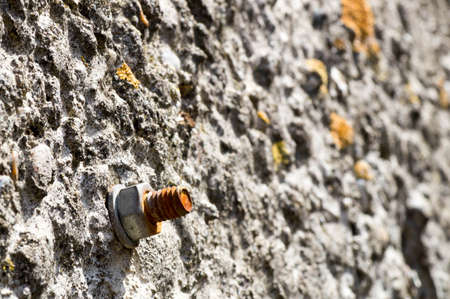 Lateral shot of a screw in the concrete wall