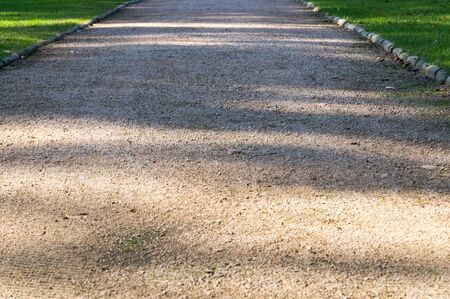 Road in lower view with shadows on itの写真素材