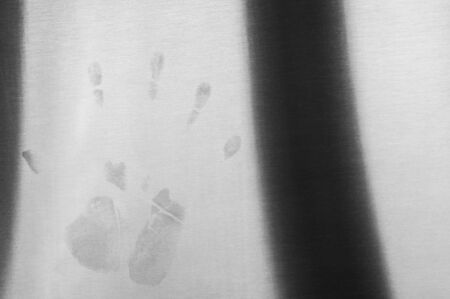 Dirty hand mark on clean shiny metal surface