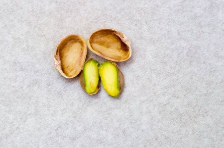 Upper shot of opened pistachio nut and it's shellの写真素材