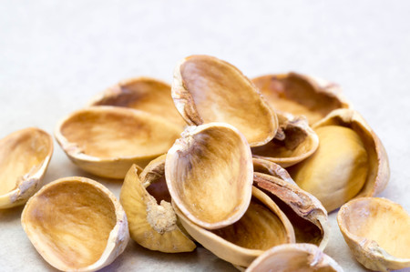 Empty pistachio nut shells on each otherの写真素材
