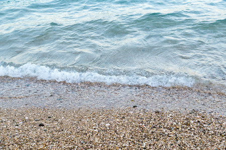 Seashore with sand and tiny rocks