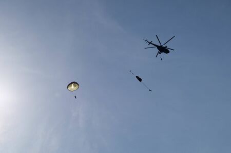 Parachuters jumping out from a helicopterの写真素材